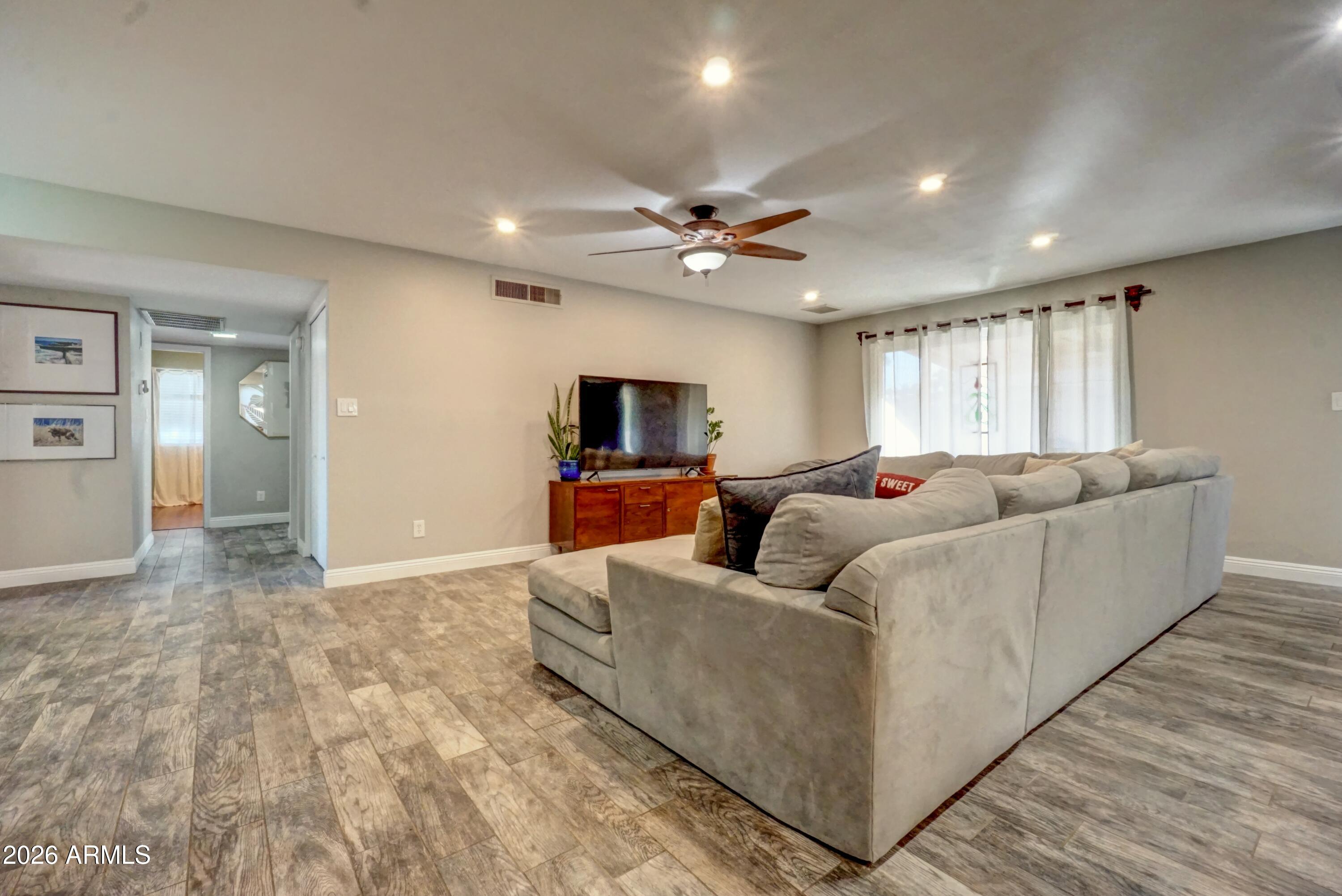 2749 East Sylvia Street Phoenix, AZ 85032 - Photo 16 of 44 a living room with furniture and a flat screen tv