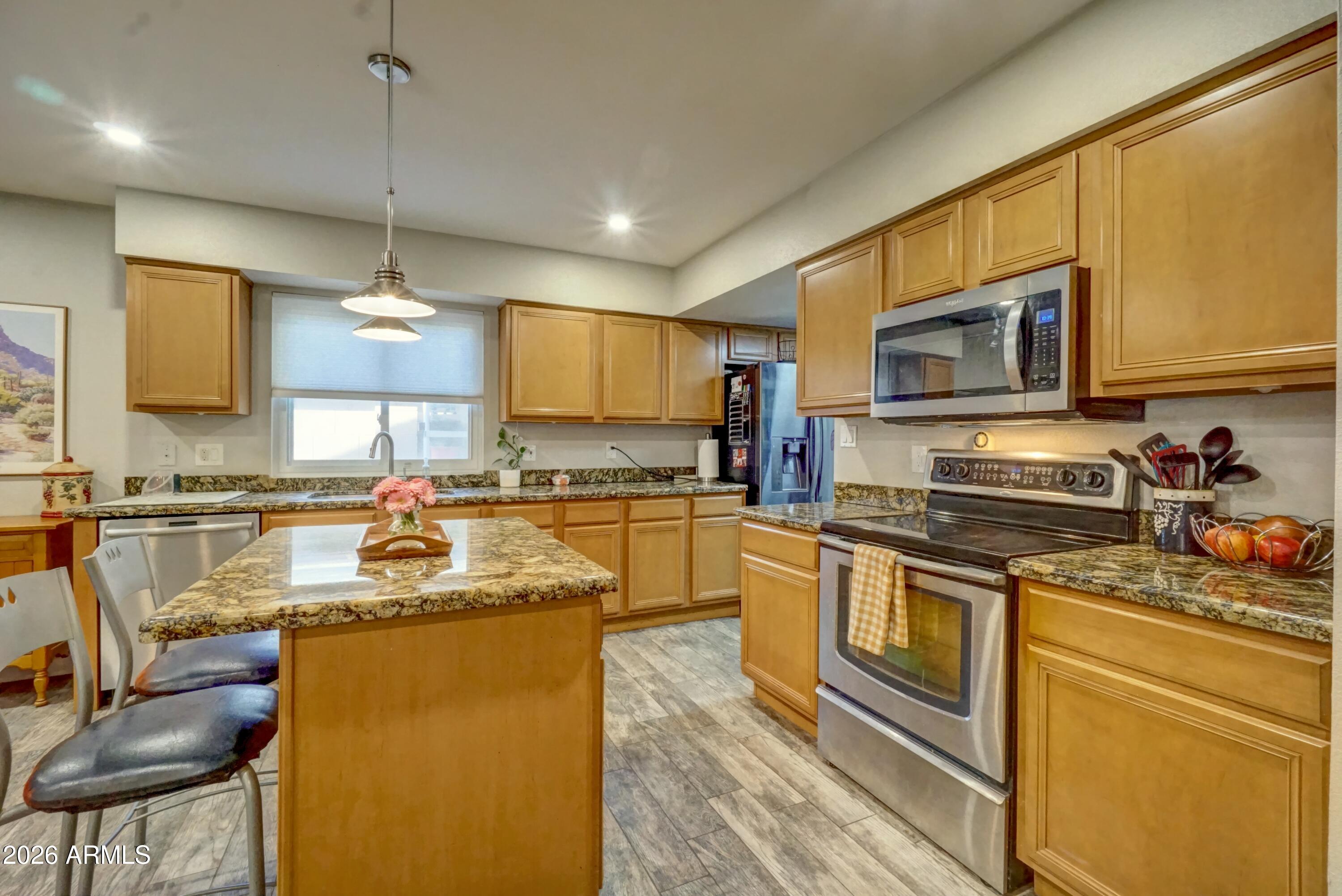 2749 East Sylvia Street Phoenix, AZ 85032 - Photo 17 of 44 a kitchen with a sink stove and microwave