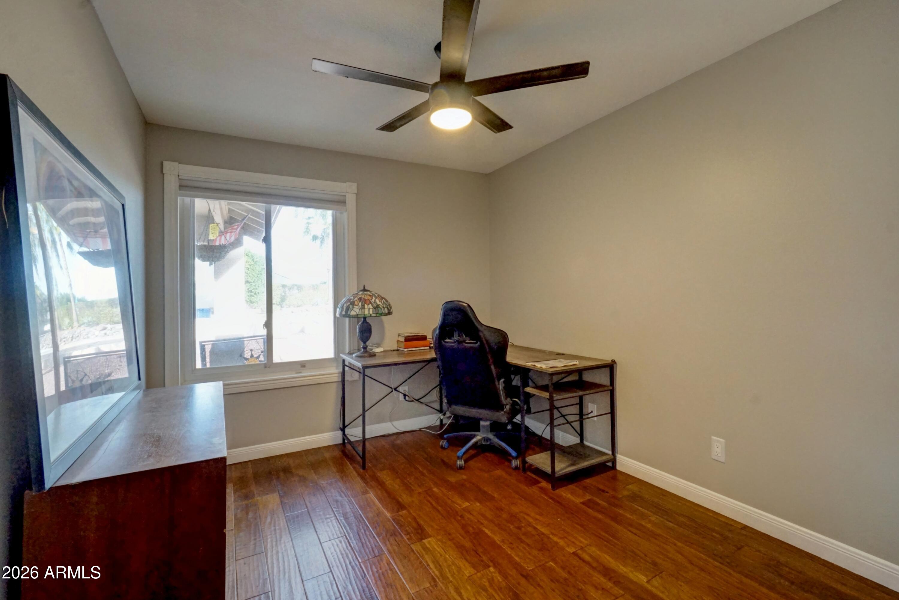 2749 East Sylvia Street Phoenix, AZ 85032 - Photo 19 of 44 a workspace with wooden floor and a window