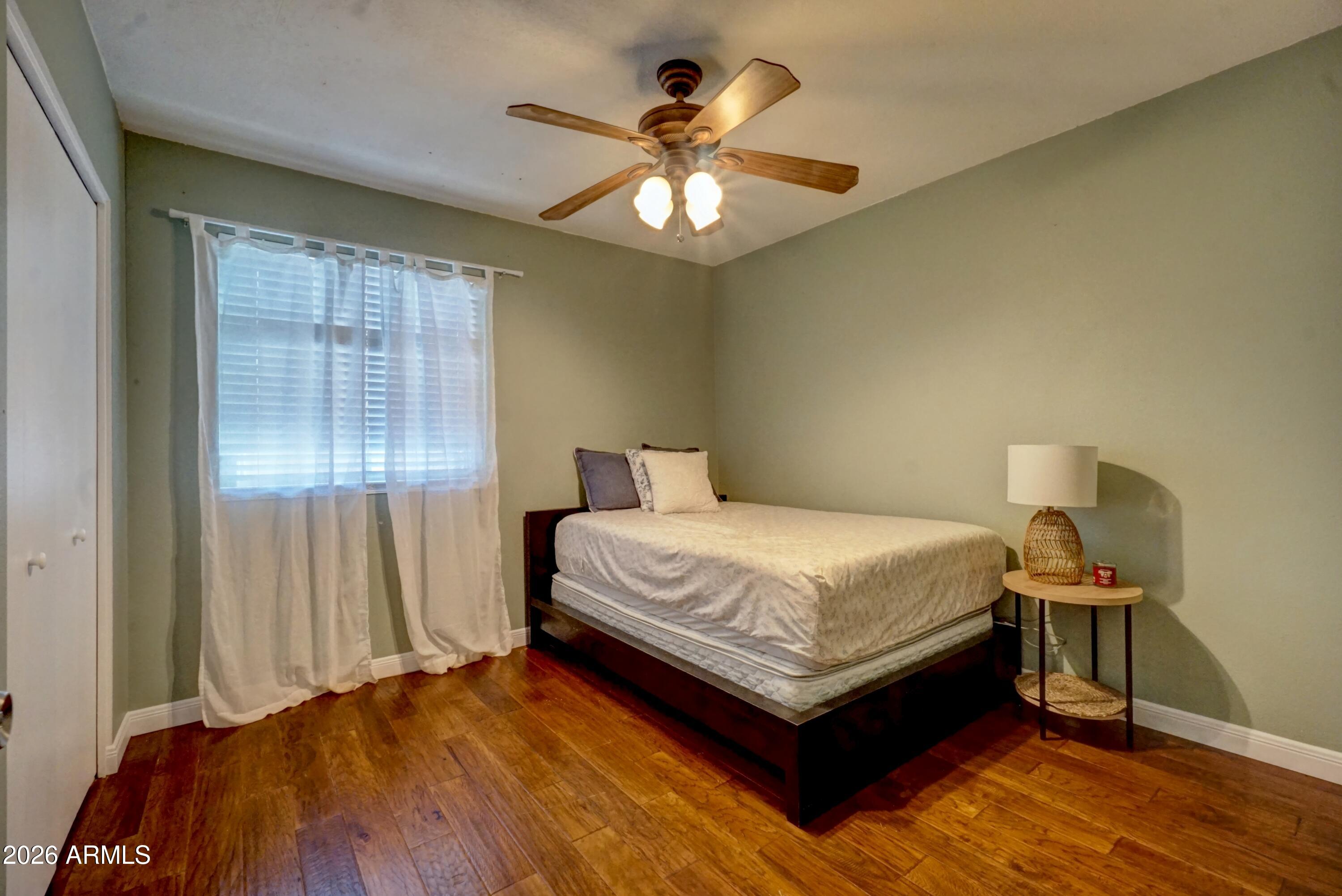 2749 East Sylvia Street Phoenix, AZ 85032 - Photo 29 of 44 a bedroom with a bed and a chandelier