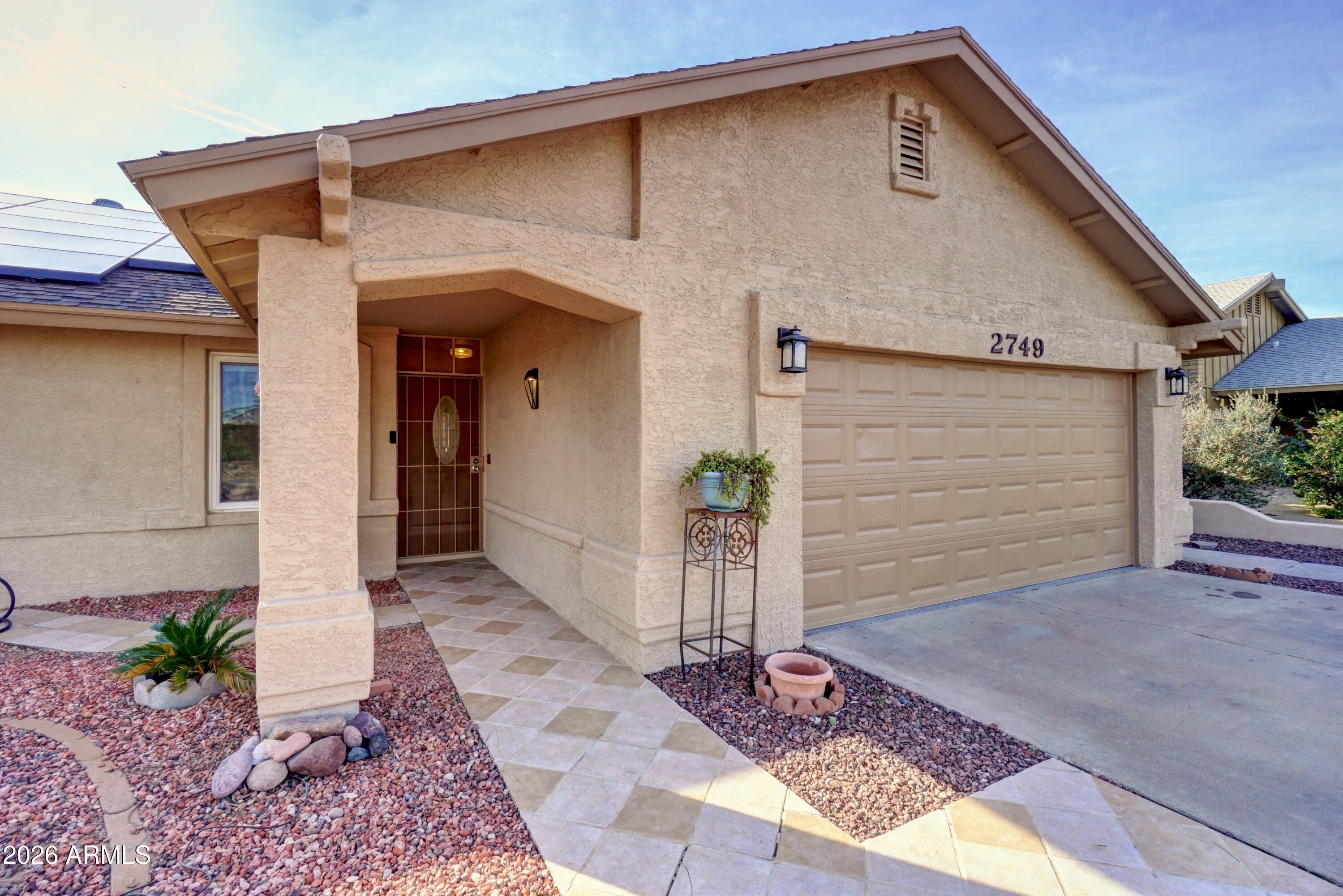 2749 East Sylvia Street Phoenix, AZ 85032 - Photo 3 of 44 a front view of a house with garden