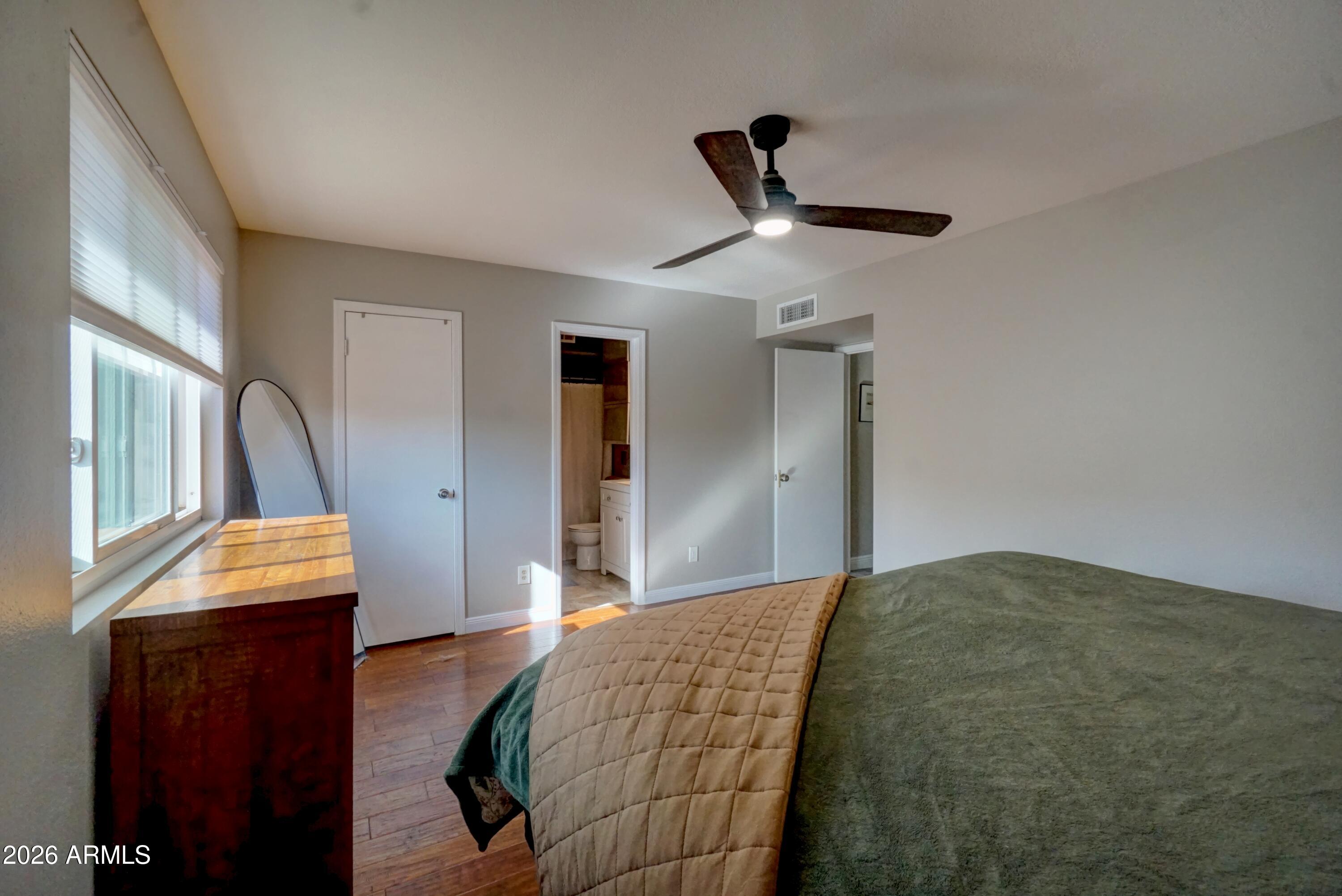 2749 East Sylvia Street Phoenix, AZ 85032 - Photo 33 of 44 a bedroom with a bed and a mirror