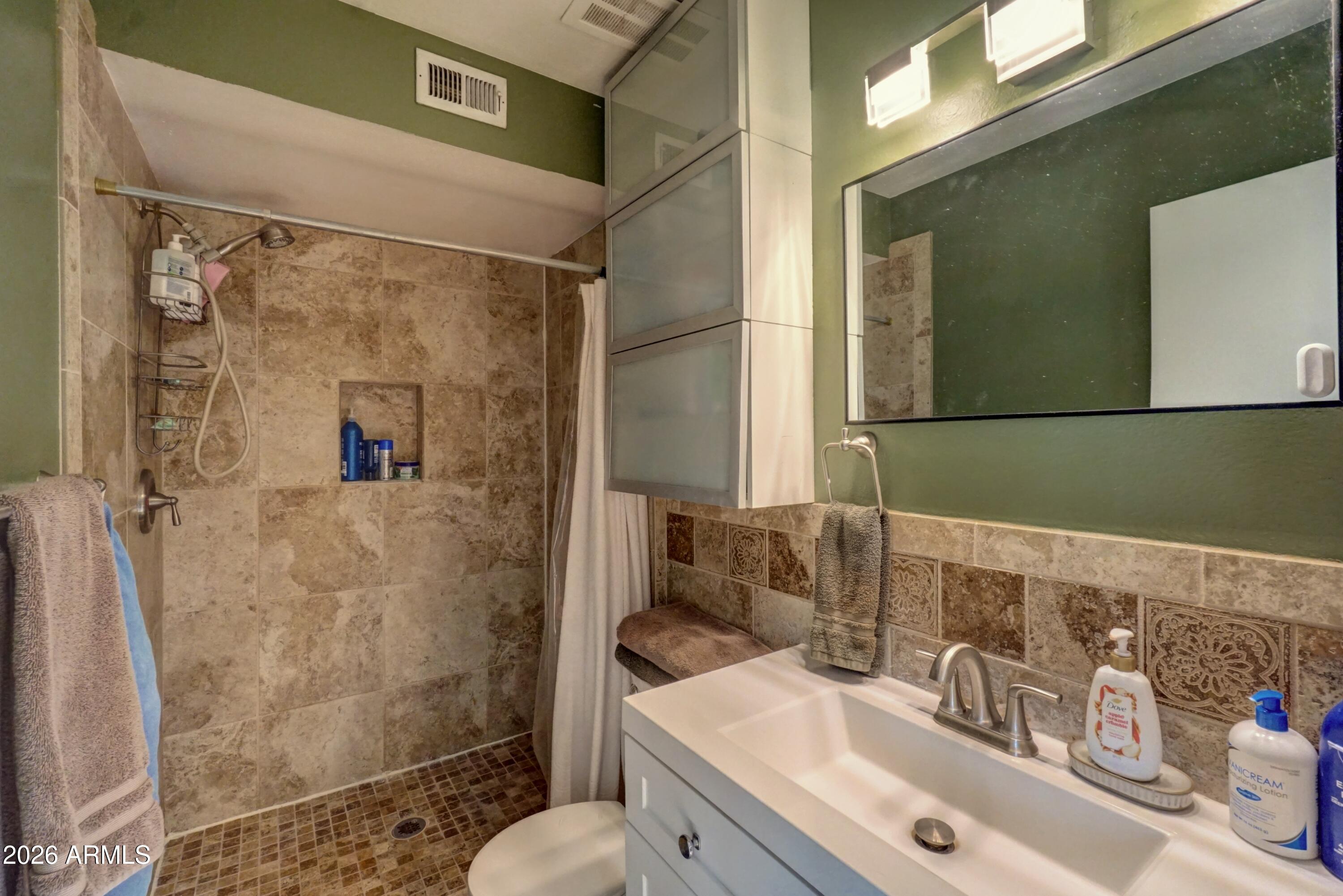 2749 East Sylvia Street Phoenix, AZ 85032 - Photo 34 of 44 a bathroom with a sink and a mirror