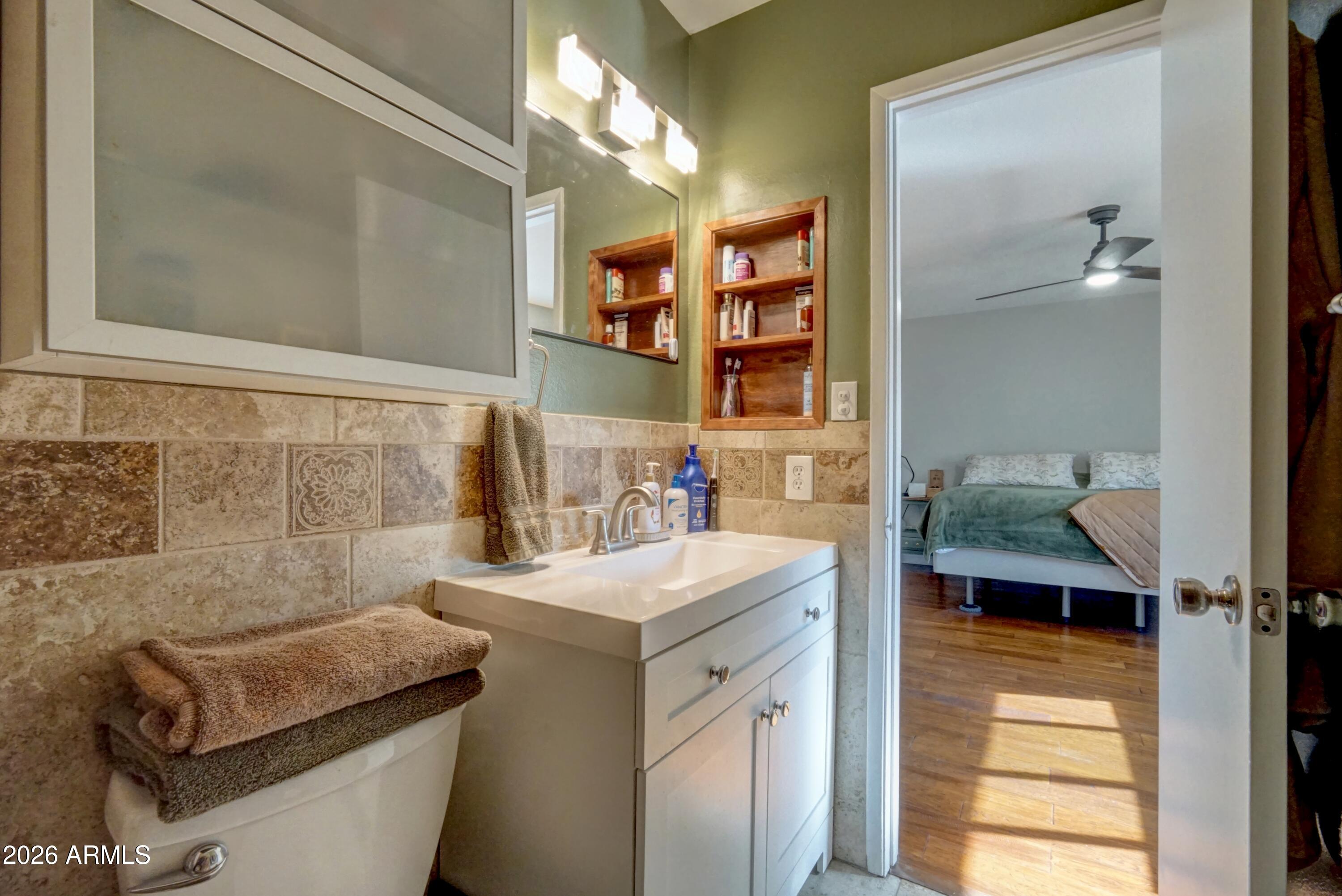 2749 East Sylvia Street Phoenix, AZ 85032 - Photo 35 of 44 a bathroom with a sink and a mirror