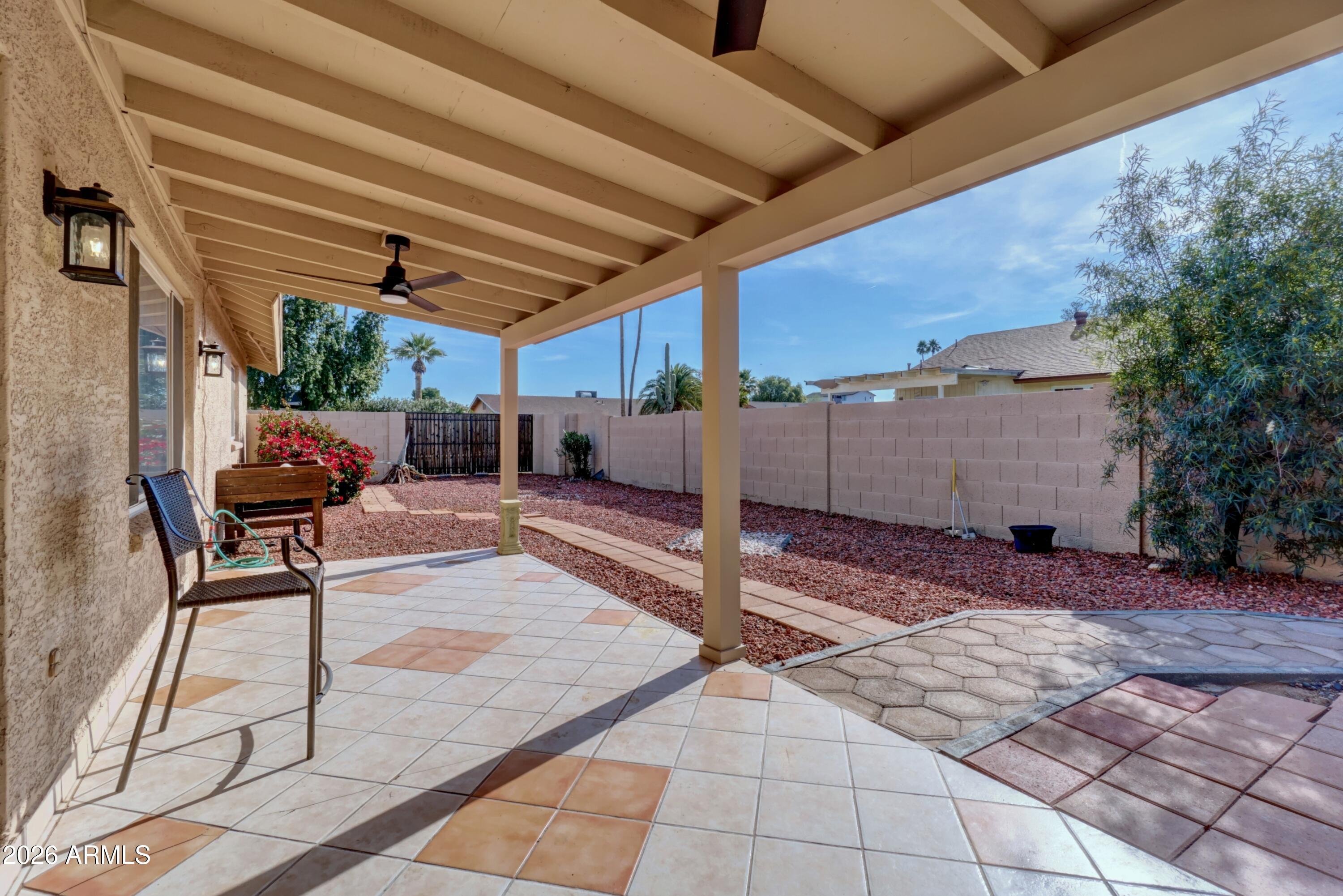 2749 East Sylvia Street Phoenix, AZ 85032 - Photo 37 of 44 a patio with table and chairs and potted plants