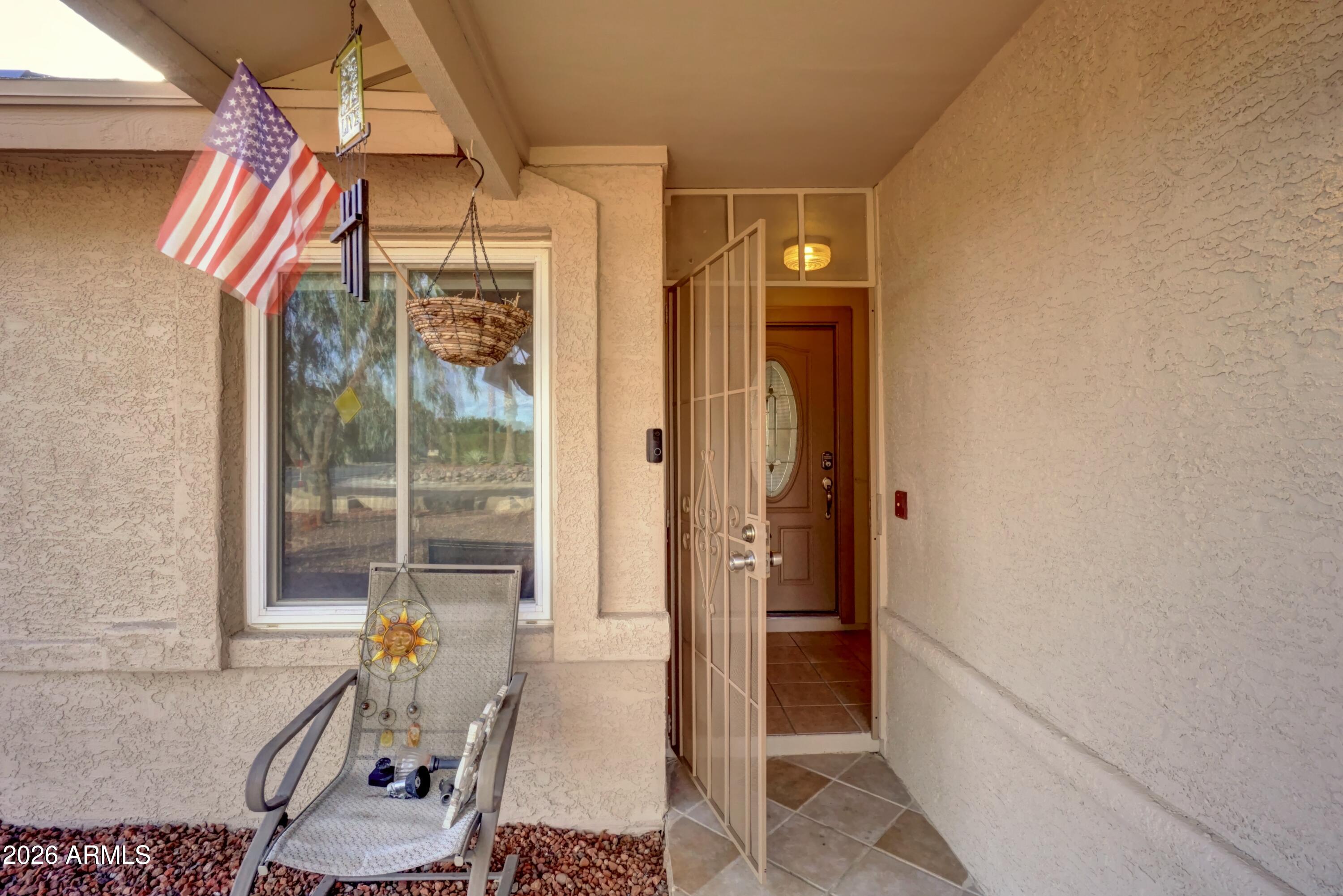 2749 East Sylvia Street Phoenix, AZ 85032 - Photo 4 of 44 a view of a hallway with wooden floor and furniture