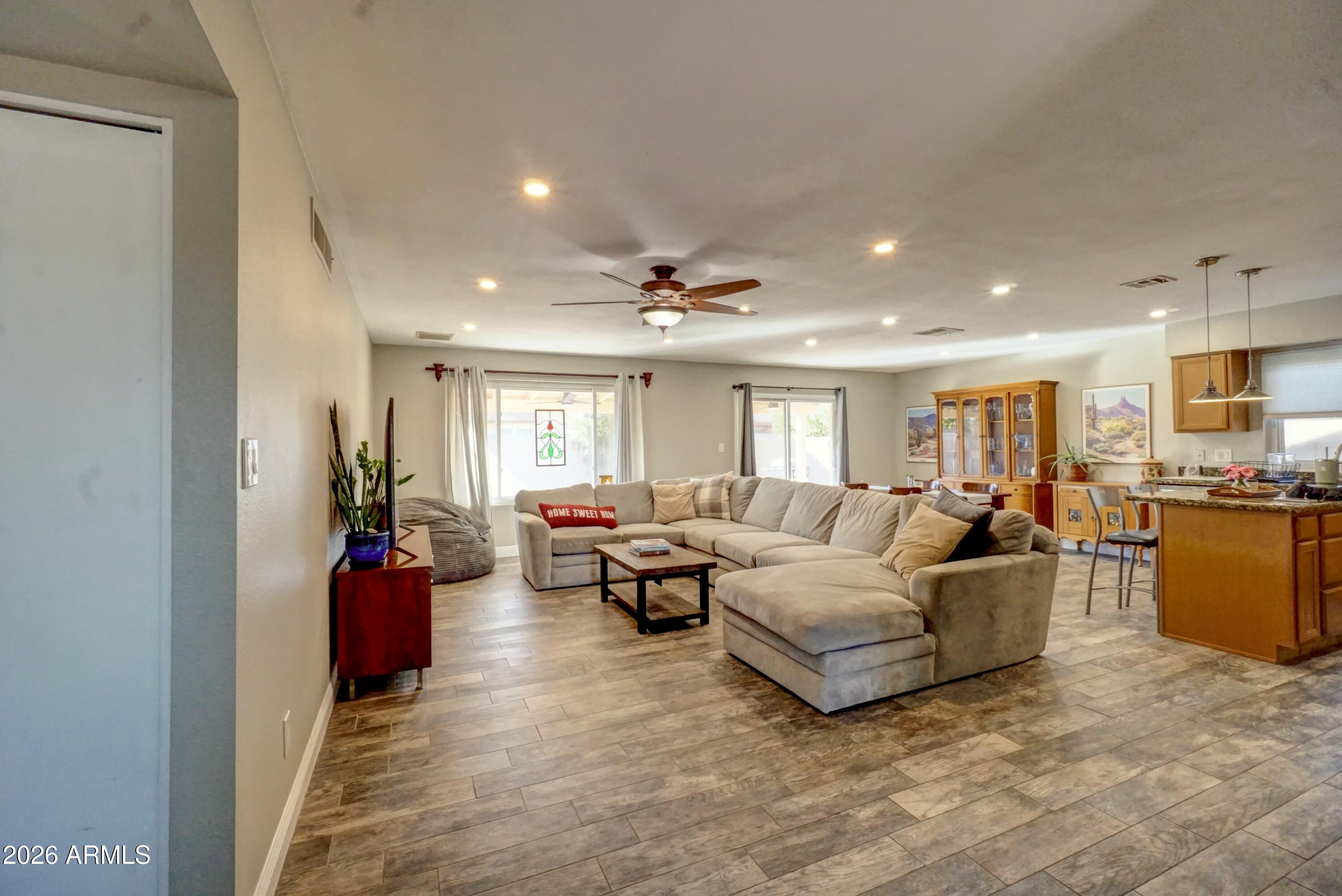 2749 East Sylvia Street Phoenix, AZ 85032 - Photo 7 of 44 a living room with furniture and a chandelier