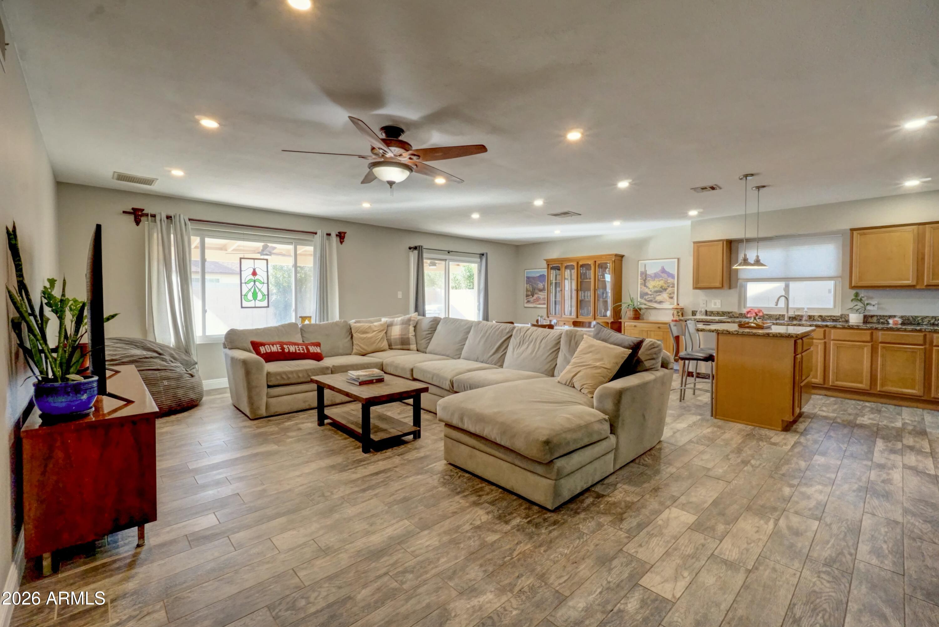 2749 East Sylvia Street Phoenix, AZ 85032 - Photo 8 of 44 a living room with furniture kitchen view and a large window