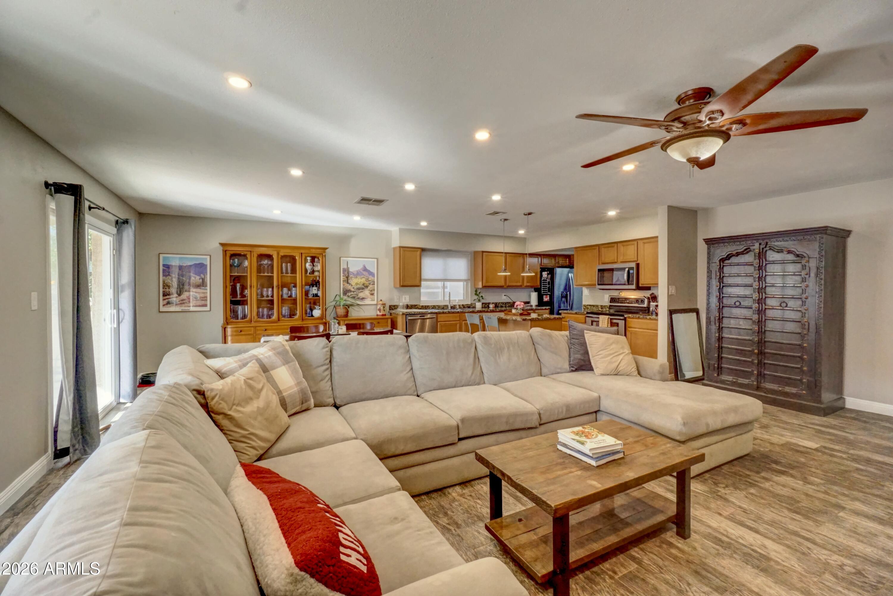 2749 East Sylvia Street Phoenix, AZ 85032 - Photo 10 of 44 a living room with furniture kitchen view and a wooden floor