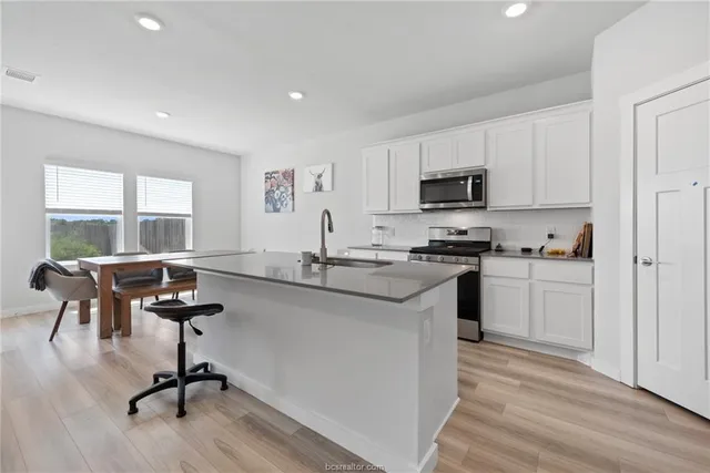 a kitchen with a sink cabinets and window