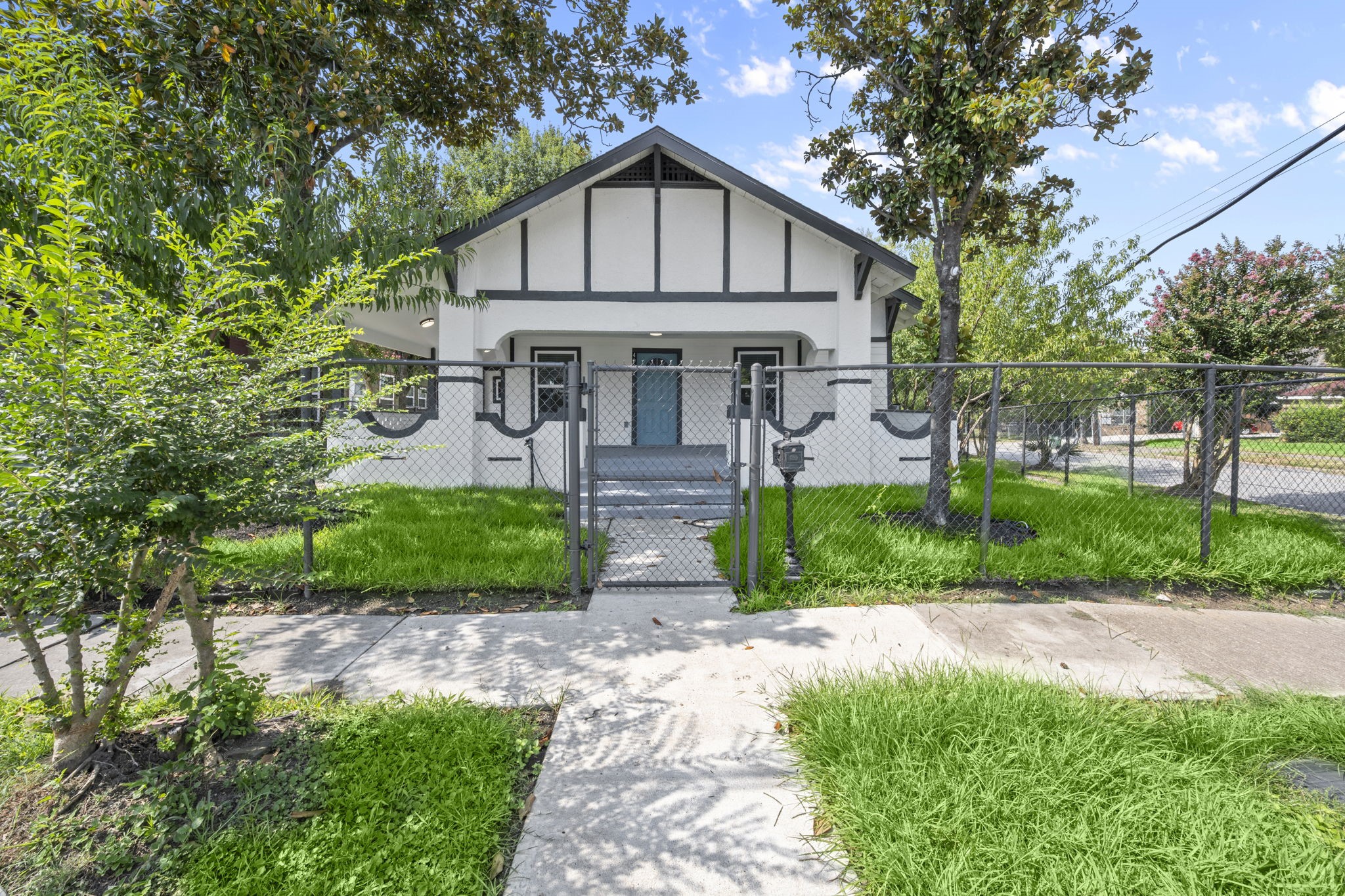 a front view of a house with a garden and plants