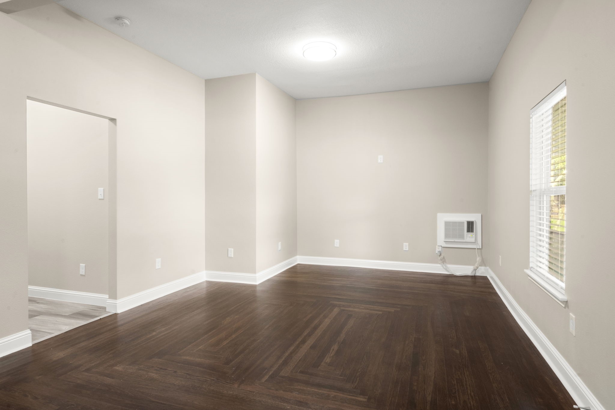 4902 McKinney Street Houston, TX 77023 - Photo 11 of 31 an empty room with wooden floor and windows