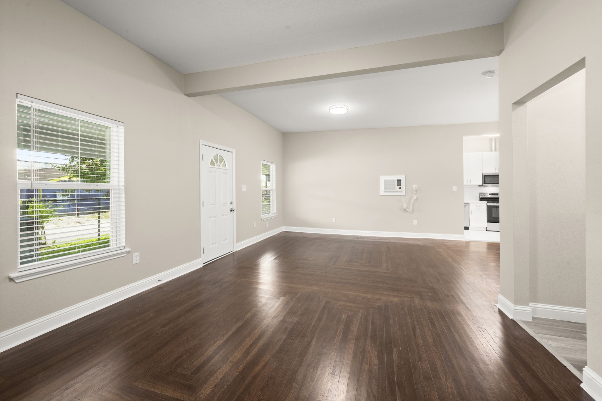 4902 McKinney Street Houston, TX 77023 - Photo 13 of 31 an empty room with wooden floor and windows