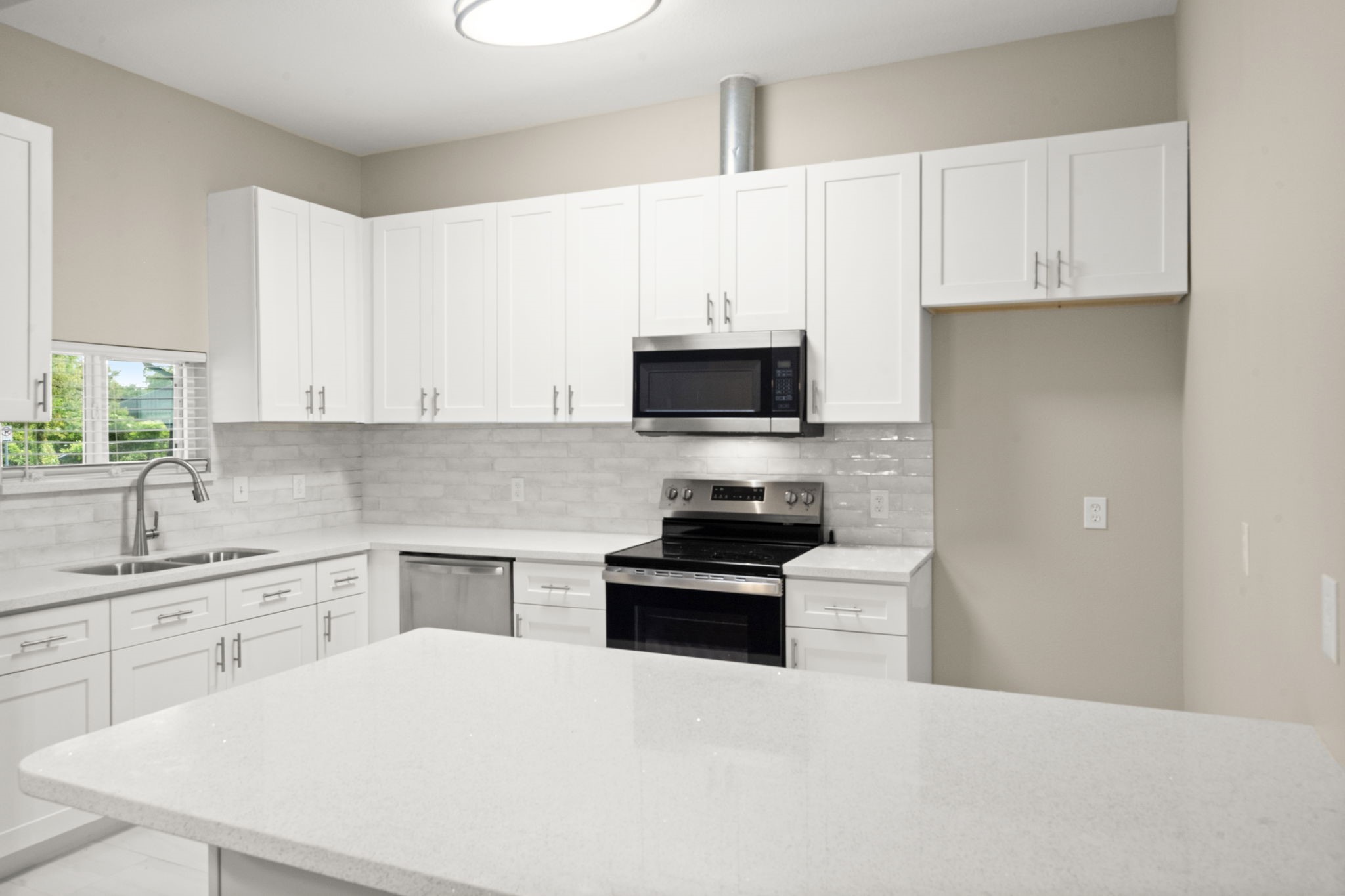 4902 McKinney Street Houston, TX 77023 - Photo 17 of 31 a kitchen with white cabinets and appliances