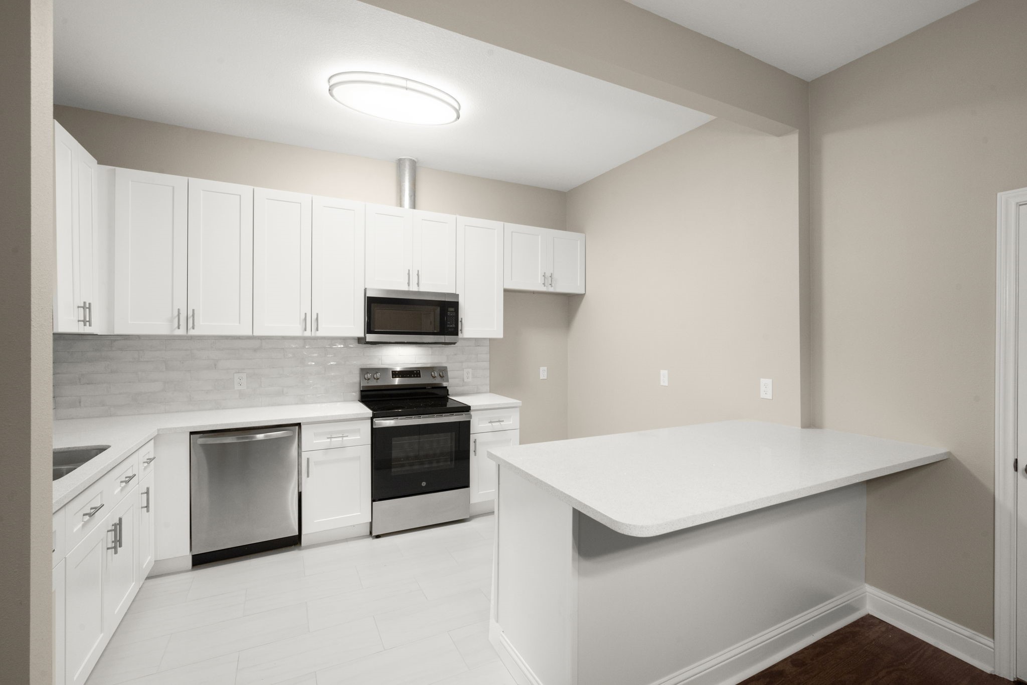 4902 McKinney Street Houston, TX 77023 - Photo 18 of 31 a kitchen with granite countertop white cabinets and white appliances