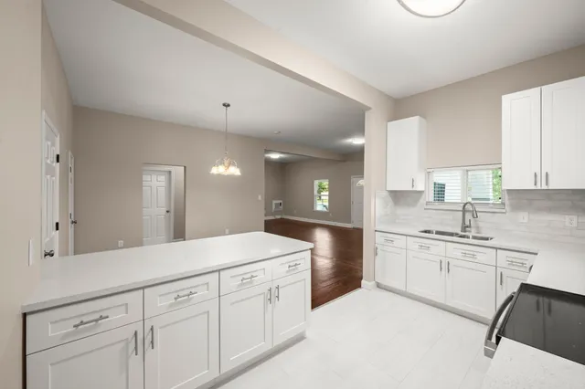 a spacious bathroom with a granite countertop sink mirror and cabinets