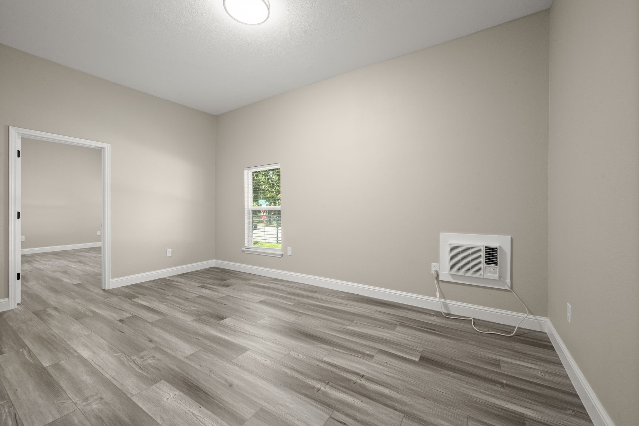 4902 McKinney Street Houston, TX 77023 - Photo 24 of 31 an empty room with wooden floor and windows