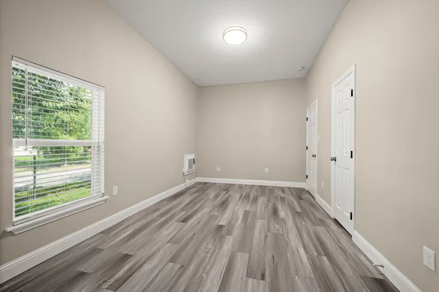wooden floor in an empty room with a window