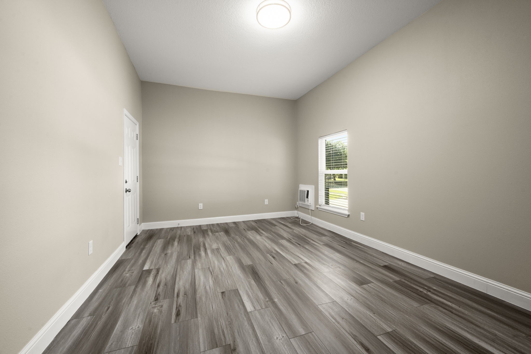 4902 McKinney Street Houston, TX 77023 - Photo 26 of 31 a view of an empty room with wooden floor and a window