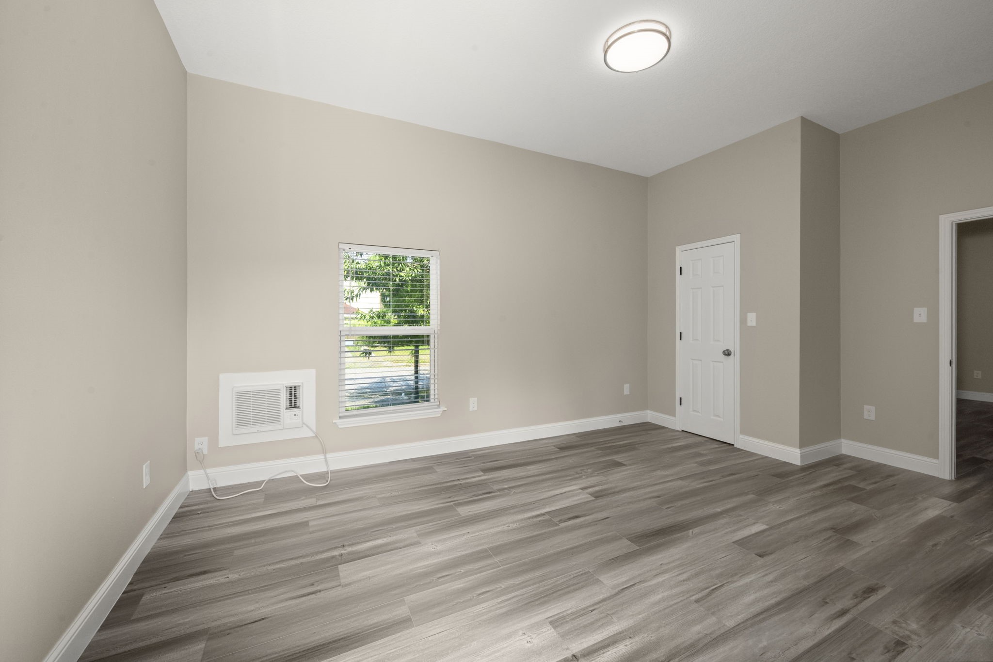 4902 McKinney Street Houston, TX 77023 - Photo 27 of 31 a view of an empty room with wooden floor and a window