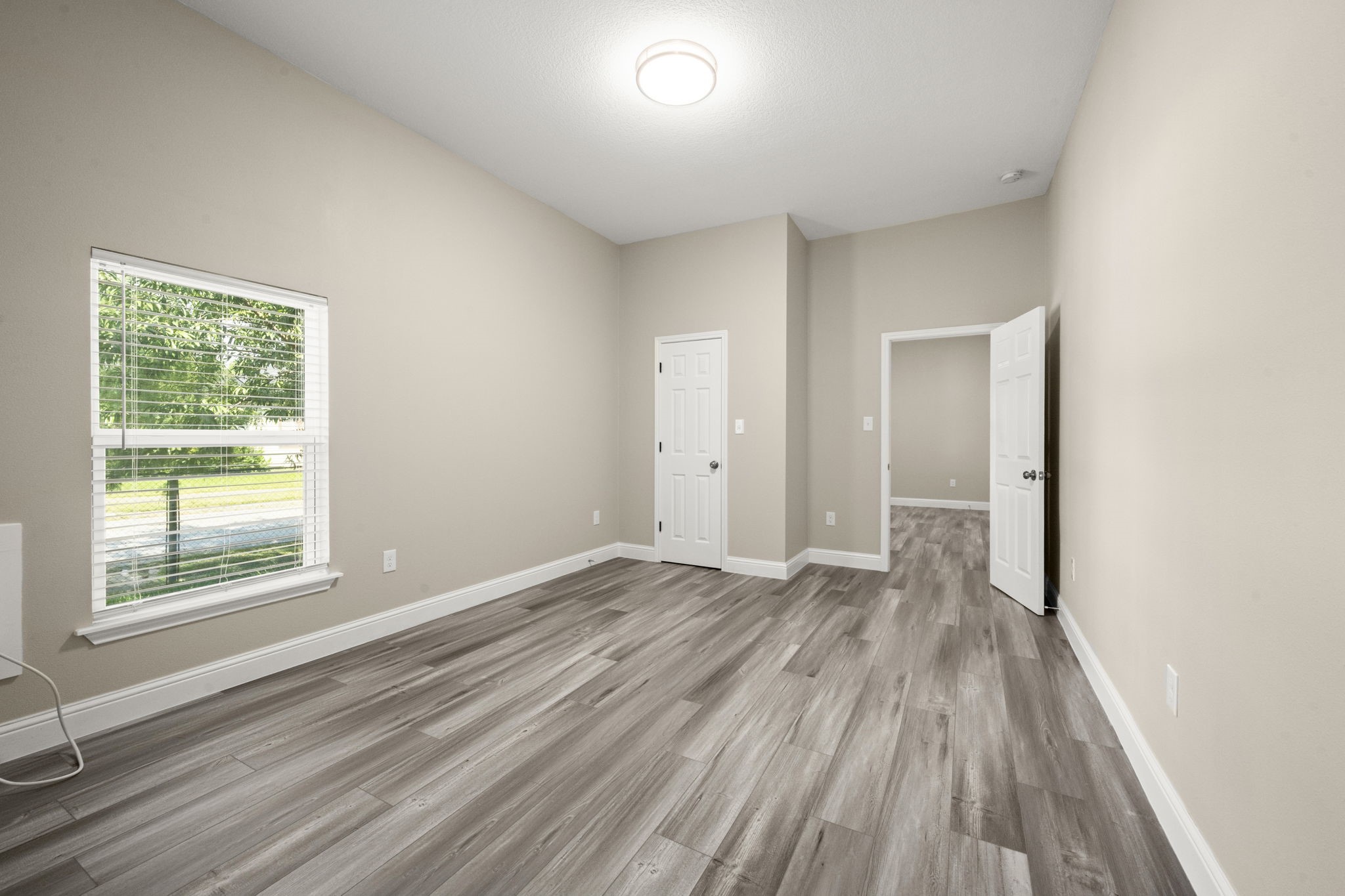4902 McKinney Street Houston, TX 77023 - Photo 28 of 31 a view of an empty room with wooden floor and a window