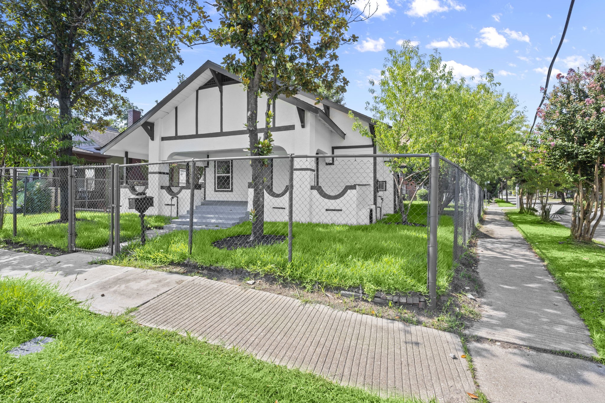 4902 McKinney Street Houston, TX 77023 - Photo 3 of 31 a view of a big house with a big yard and large trees