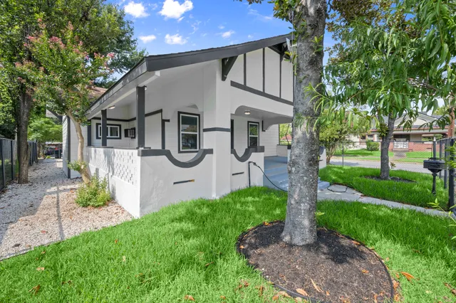 a front view of house with a garden