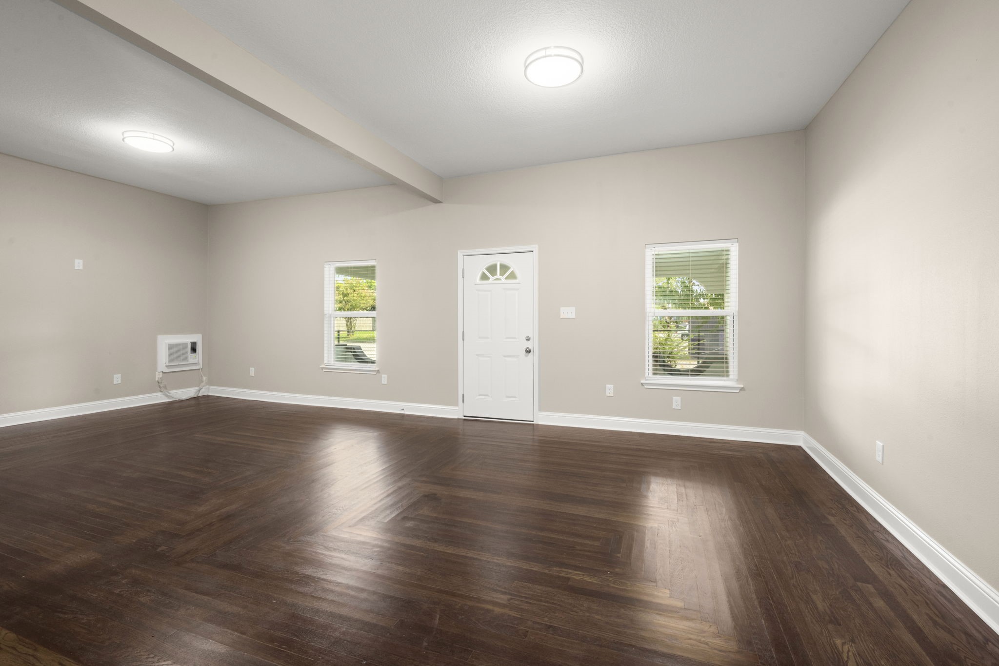 4902 McKinney Street Houston, TX 77023 - Photo 9 of 31 an empty room with wooden floor and windows