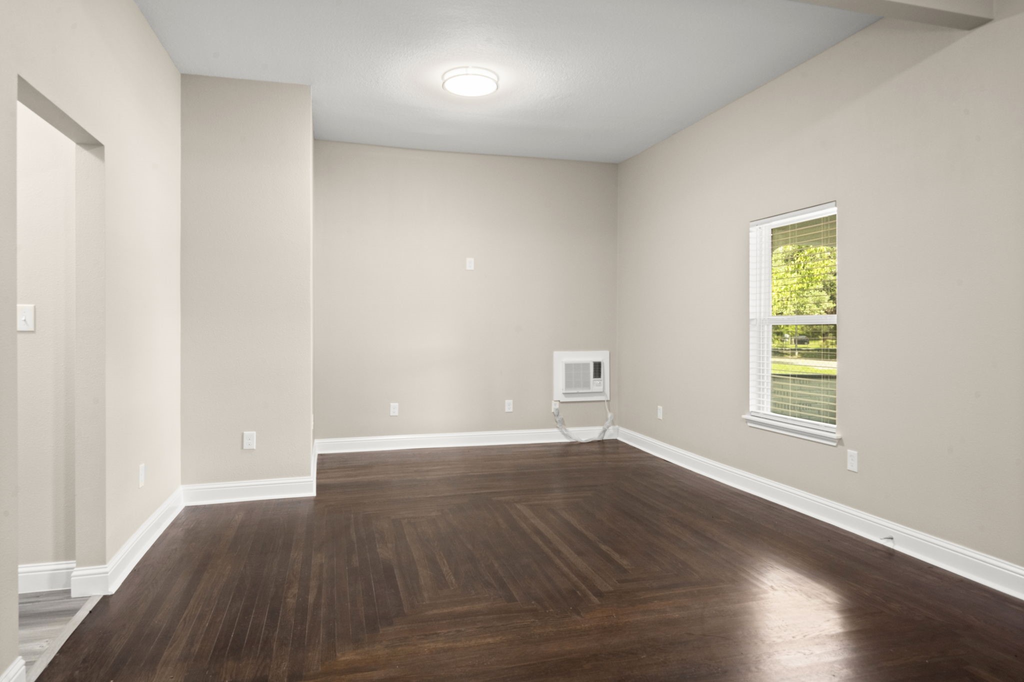 4902 McKinney Street Houston, TX 77023 - Photo 10 of 31 an empty room with wooden floor and windows