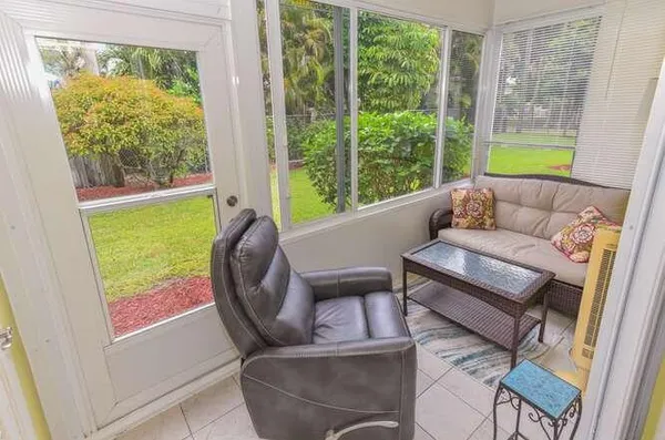 a living room with patio furniture and a window