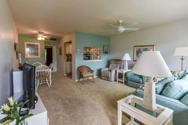 a living room with furniture and a lamp