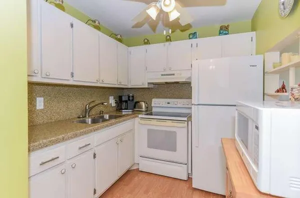 a kitchen with cabinets appliances and a counter space