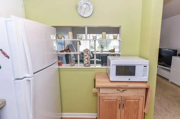 a kitchen with a refrigerator and a stove