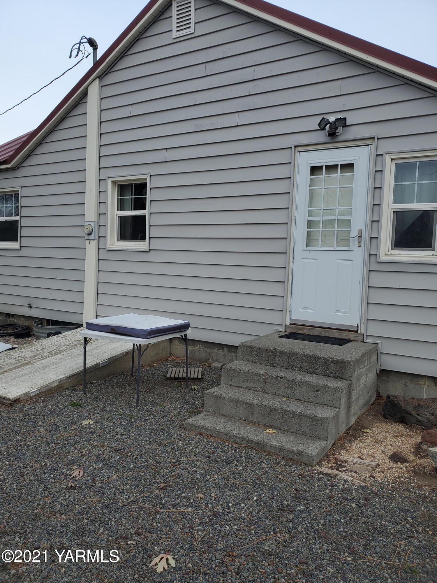 1090 Snipes Pump Road Sunnyside, WA 98944 - Photo 13 of 19 a view of a house with a yard and a chair