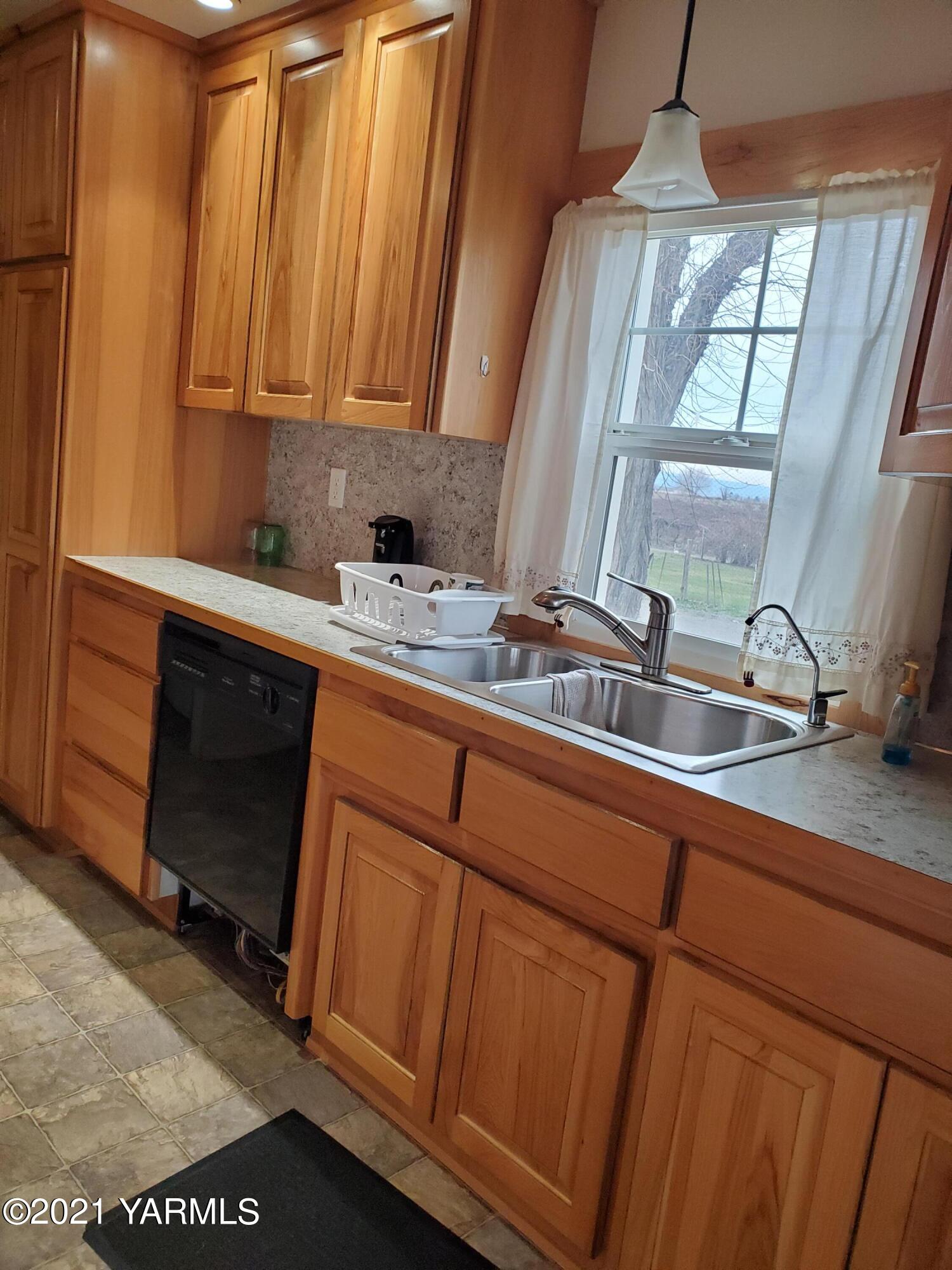 1090 Snipes Pump Road Sunnyside, WA 98944 - Photo 5 of 19 a kitchen with a sink and cabinets