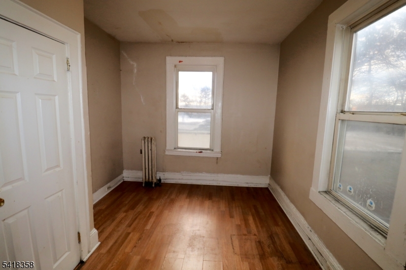 413 Lyons Avenue, Unit 2L Newark, NJ 07112 - Photo 13 of 15 a view of a room with wooden floor and window
