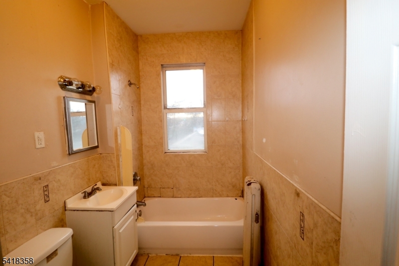 413 Lyons Avenue, Unit 2L Newark, NJ 07112 - Photo 14 of 15 a bathroom with a sink toilet and shower