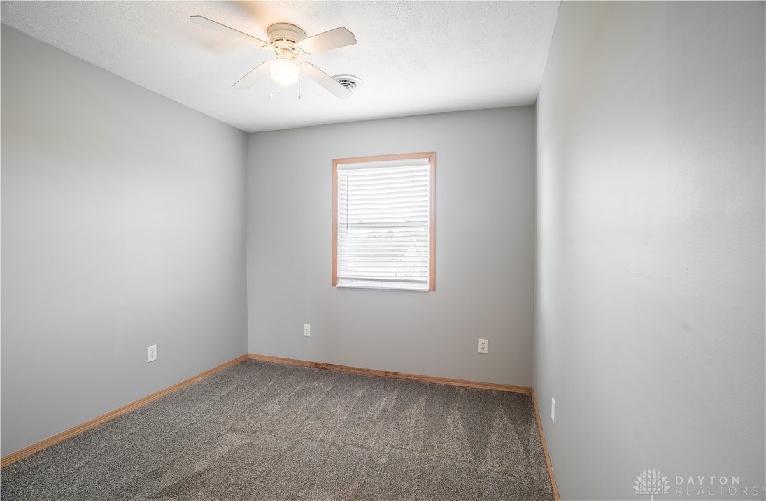 1442 Langdon Road Sidney, OH 45365 - Photo 25 of 34 This spacious bedroom offers ample natural light and a comforting atmosphere for peaceful relaxation.
