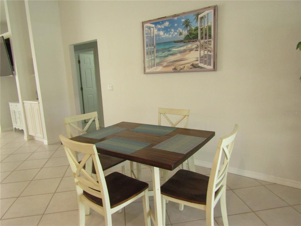 142 Solana Street North Port, FL 34287 - Photo 5 of 17 a view of a dining room with furniture and wooden floor