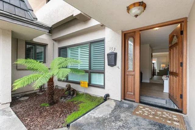 a view of a porch with chairs and backyard
