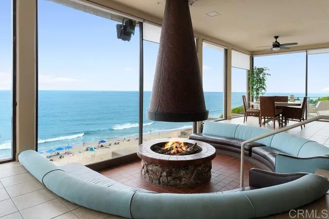 a living room with furniture and a floor to ceiling window
