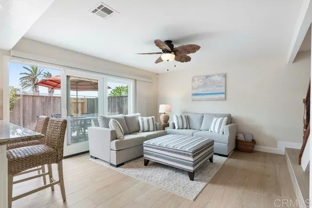 a spacious bedroom with a bed a couch and a chandelier