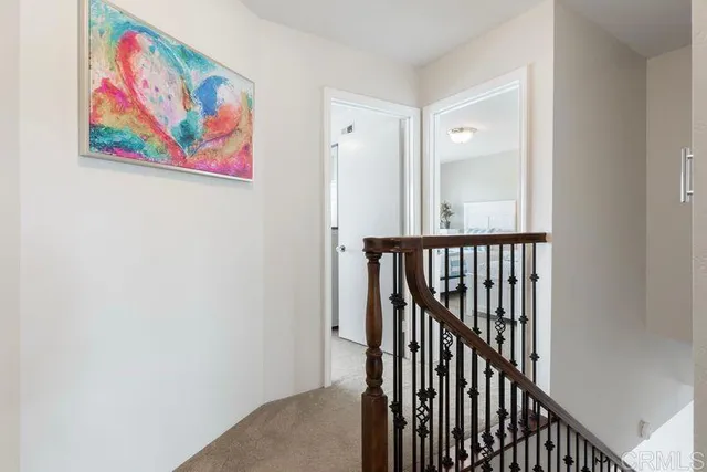 a view of a hallway with wooden floor and door