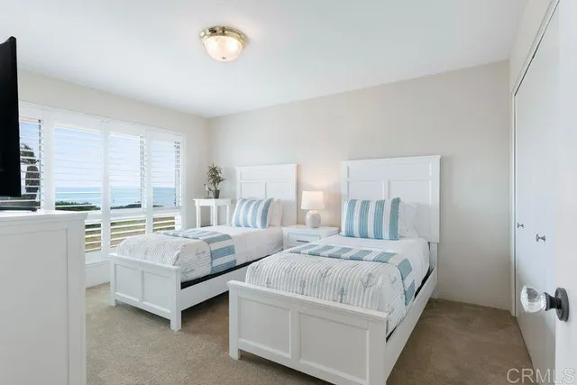 a bedroom with a bed and a night stand