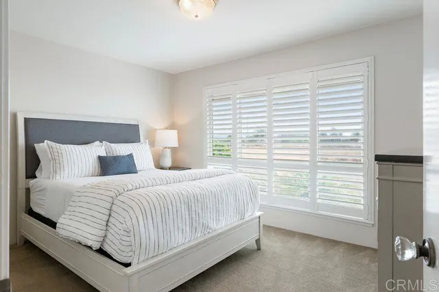 a bedroom with a bed and window