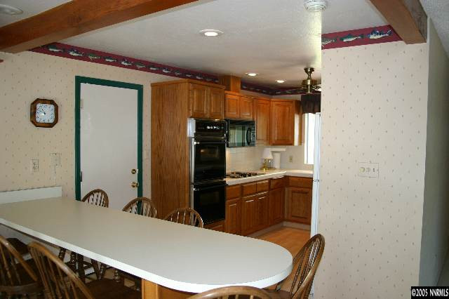 1535 Lillian Way Reno, NV 89509 - Photo 2 of 7 a kitchen with a refrigerator and a sink