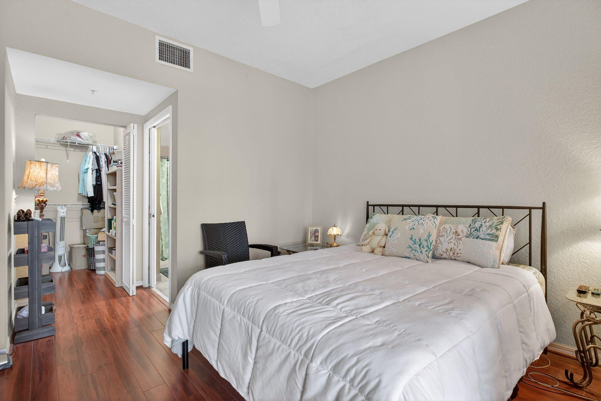 6890 West Sample Road, Unit 6890 Pompano Beach, FL 33063 - Photo 12 of 36 a bedroom with a large bed and wooden floor