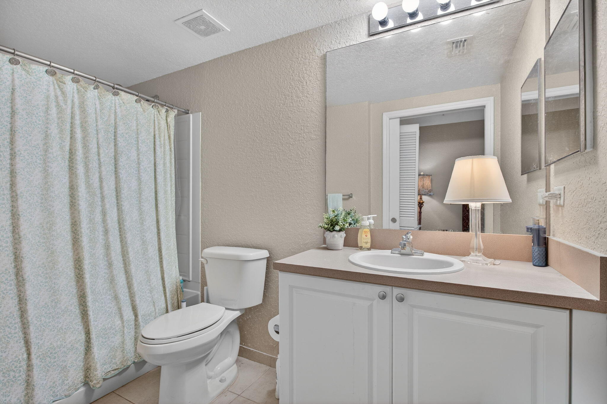 6890 West Sample Road, Unit 6890 Pompano Beach, FL 33063 - Photo 13 of 36 a bathroom with a granite countertop sink and a mirror