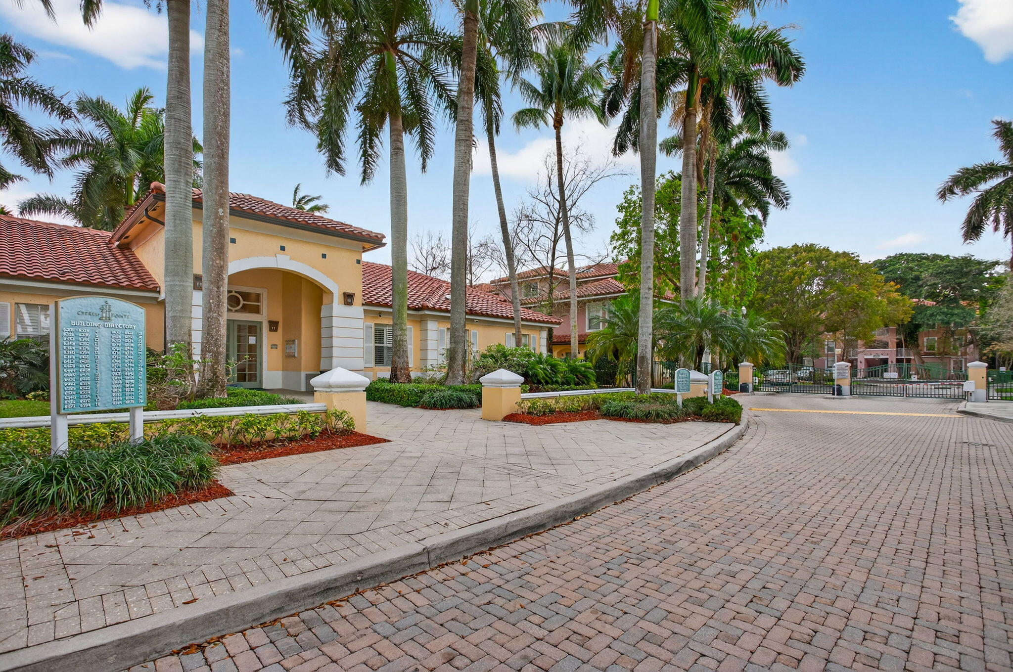 6890 West Sample Road, Unit 6890 Pompano Beach, FL 33063 - Photo 18 of 36 a row of palm trees in front of a house
