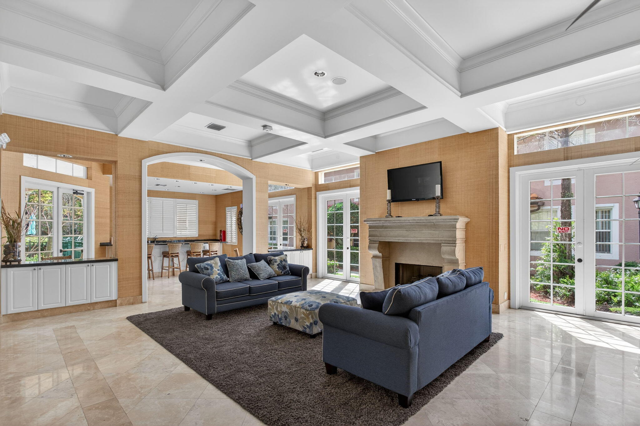 6890 West Sample Road, Unit 6890 Pompano Beach, FL 33063 - Photo 19 of 36 a living room with furniture a flat screen tv and a fireplace